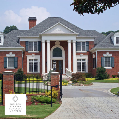 house with front lawn and driveway brick pavers