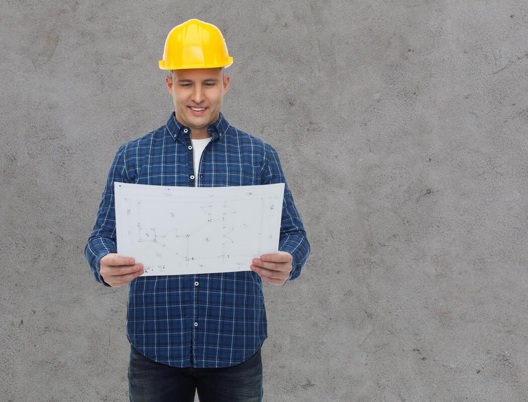 man holding a construction plan